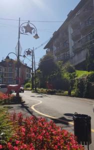 a street with flowers on the side of a road at Apart Hotel Pousada do Serrano in Gramado +13 photos