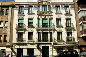 a large white building on a city street at Apartamentos Dali Madrid in Madrid