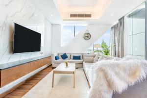 a living room with a couch and a tv at RAKvista Residence in Ras al Khaimah