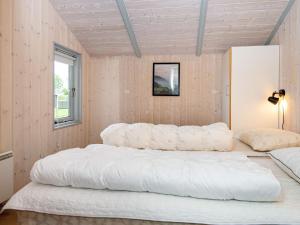 a large white bed in a room with a window at 8 person holiday home in Børkop-By Traum in Børkop