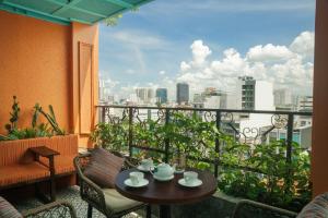 a balcony with a table and chairs and a view of the city at Alagon City Hotel & Spa in Ho Chi Minh City