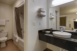 a bathroom with a sink and a toilet and a mirror at Motel 6-Port Allen, LA - Baton Rouge in Port Allen
