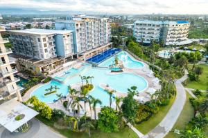 an aerial view of a large swimming pool at a resort at Solea Mactan Resort in Mactan