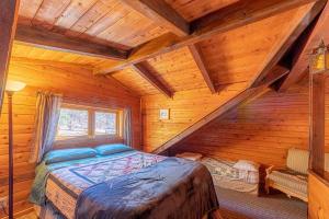 a bedroom with a bed in a log cabin at Forest Cabin 2 Birds Nest in Payson