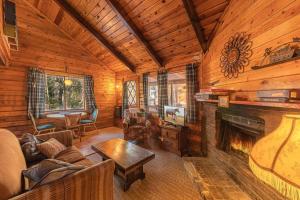 a living room with a fireplace in a log cabin at Forest Cabin 6 Enchanted Forest in Payson