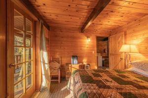 a bedroom with a bed in a wooden cabin at Forest Cabin 6 Enchanted Forest in Payson