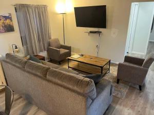 a living room with a couch and a table and a tv at Forest Cabin 7 Seventh Heaven in Payson