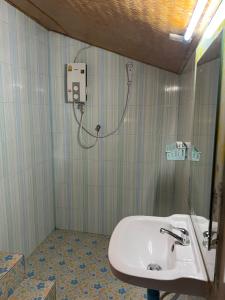 a bathroom with a sink and a shower at Coco Sunset Beach in Ban Bang Po