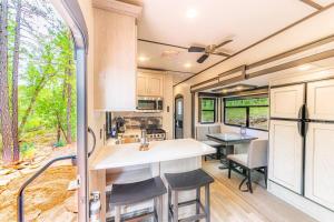 a kitchen and dining area of an rv at Luxury Glamper Retreat 14 Forest Site in Payson