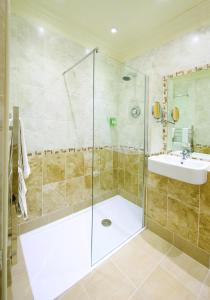 a bathroom with a shower and a sink at Orton Hall Hotel & Spa in Peterborough