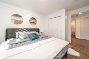 a bedroom with a large bed with two mirrors on the wall at Stylish Close to D/T FREE parking King Bed 2bed in Edmonton