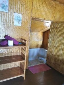 a bathroom with a bunk bed and a toilet at Coco Sunset Beach in Ban Bang Po