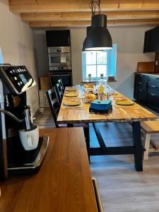 a large wooden table in a kitchen with a dining room at RingLodge in Kelberg