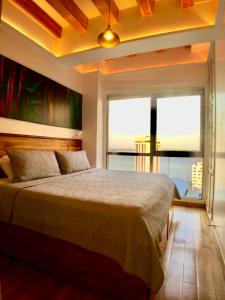 a bedroom with a large bed and a large window at Luxury Apartment Heart Of Guayaquil in Guayaquil