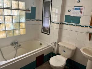 a bathroom with a tub and a toilet and a sink at First Villa Beach Resort in Ban Tai