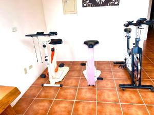 a gym with treadmills and exercise bikes on a tile floor at 溪頭18號 in Lugu Lake