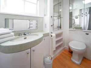 a white bathroom with a sink and a toilet at Please do not book in London