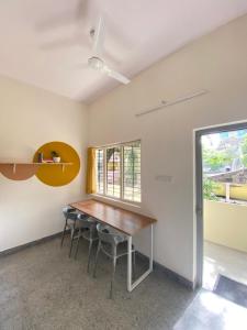 an empty room with a wooden table and chairs at Habitat15@airlines in Bangalore