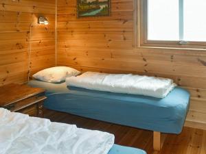 เตียงในห้องที่ Three-Bedroom Holiday home in Selje 1