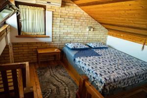 a bedroom with a bed in a wooden house at Hidden Gem of Krasici in Radovići