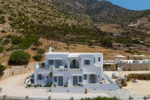 a large white house with a hill in the background at Villa Frazeska in Kamares