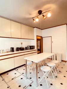 a kitchen with a table and chairs in a room at SAMURISE DARUMA in Fujiyoshida