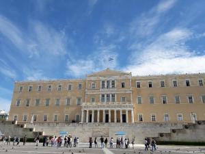 a large building with people walking in front of it at Ermoo Athens Modern Living in Athens