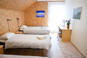 a hotel room with two beds and a window at Haapsalu Kunstikooli hostel in Haapsalu