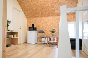 a living room with a table and a refrigerator at Haapsalu Kunstikooli hostel in Haapsalu +24 photos