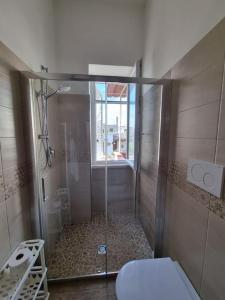 a shower with a glass door in a bathroom at Bella D'Estate - 10 minutes from the beach in Ischia