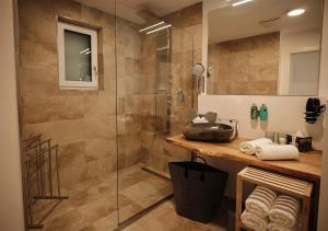 a bathroom with a shower and a sink at SEE Moment Appartements ADULTS ONLY in St. Wolfgang