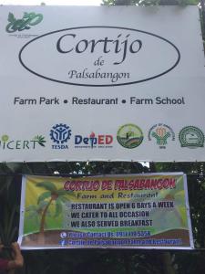 a sign for a farm park restaurant farm school at Casa De Cortijo Family Room in Pagbilao