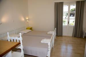 A bed or beds in a room at Irene Hotel Leros