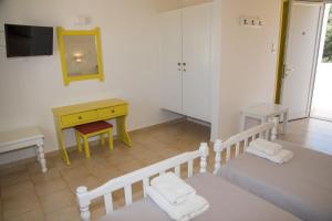 A bed or beds in a room at Irene Hotel Leros
