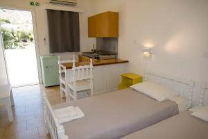 A bed or beds in a room at Irene Hotel Leros