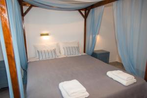 A bed or beds in a room at Irene Hotel Leros