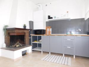 a kitchen with a fireplace in the middle of it at Casa Azzurra in Marzocca di Senigallia