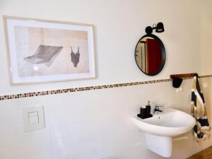 a bathroom with a sink and a mirror on the wall at Casa Azzurra in Marzocca di Senigallia +13 photos