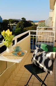 a table and a chair on a balcony with a plate of food at Casa Azzurra in Marzocca di Senigallia