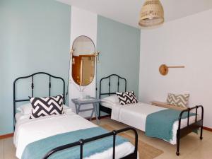 a bedroom with two beds and a mirror at Casa Azzurra in Marzocca di Senigallia