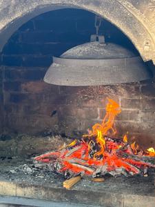 a brick oven with a fire inside of it at Apartment Ružica in Sukošan