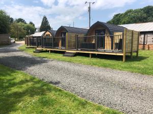 a row of wooden houses on a gravel road at Scallow Campsite in Lewes