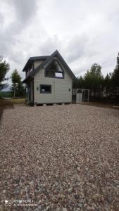 a house on top of a gravel driveway at Chatka Leo in Fornetka