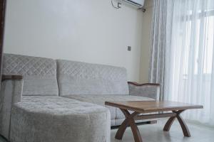 a living room with a couch and a coffee table at Hotel Comster Mtwapa in Mtwapa