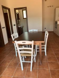 a dining room with a table and chairs at Villa Paradiso in Montegiordano +18 photos