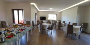 a large dining room with tables and chairs with food on them at Casa Barone in Roccadaspide