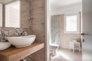 a bathroom with a white sink and a toilet at Volturno3 Suites & more in Mazara del Vallo