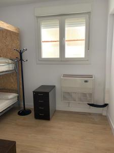 a room with a bedroom with a heater and a window at Bilbao Central Rooms in Bilbao +10 photos
