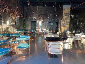 a dining room with tables and chairs in a room at NENESSAHOTEL in Aksaray