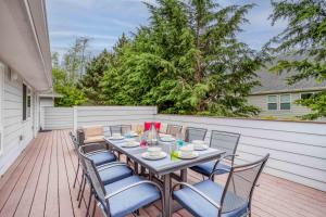a patio with a table and chairs on a deck at Family Tides - Meredith Lodging in Neskowin